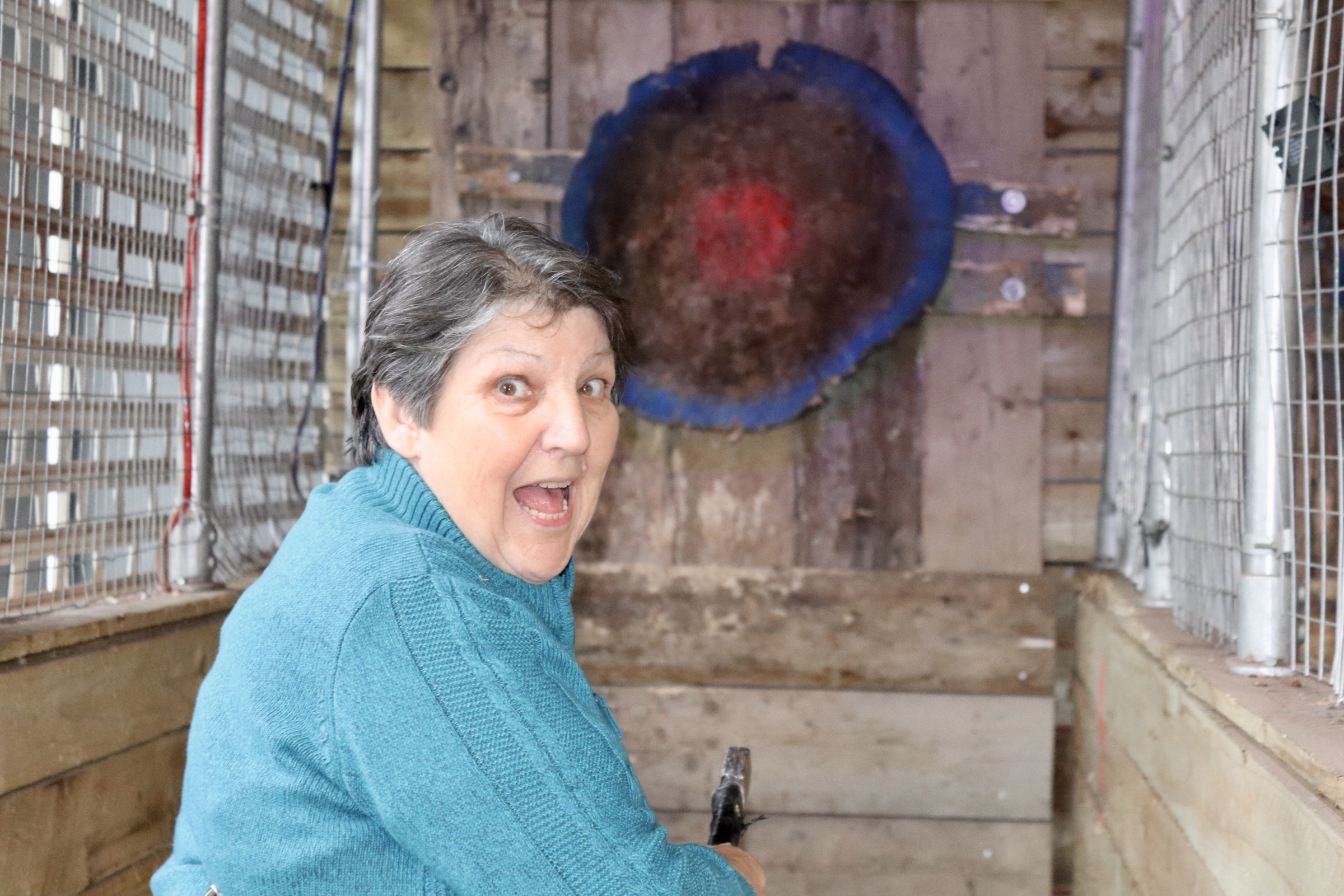 Guest enjoying axe throwing at No Name Bar and Games