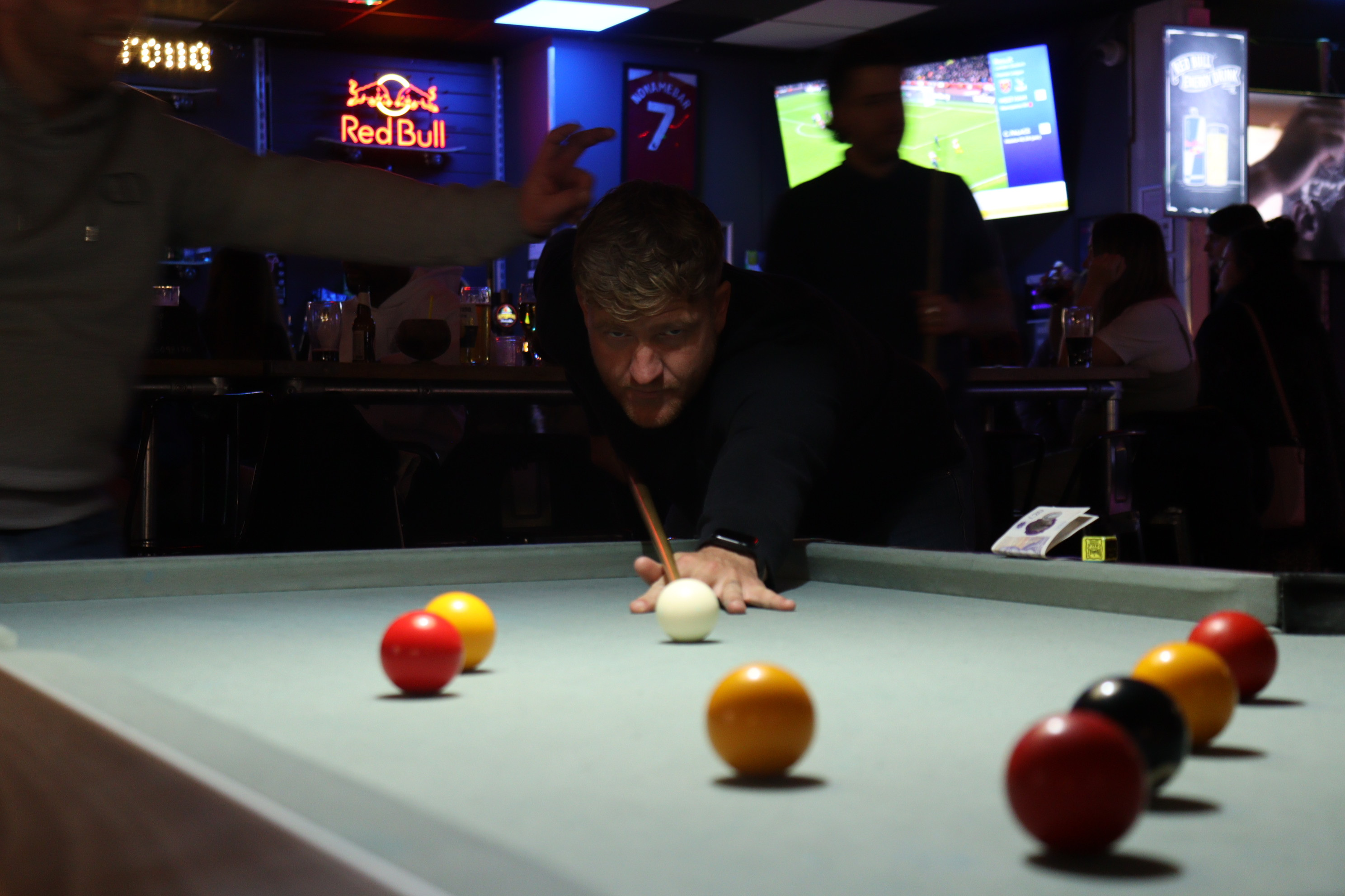 guest playing pool at No Name Bar and Games