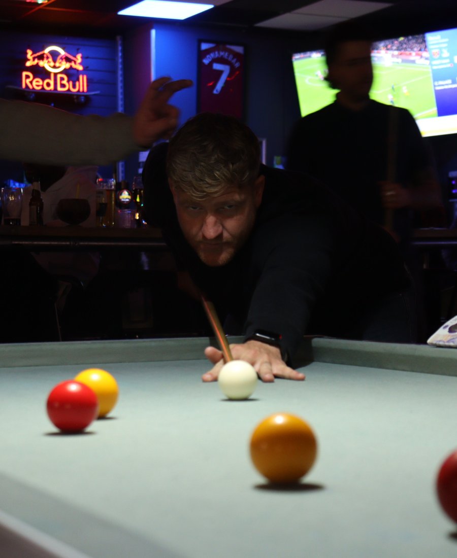 guest playing pool at No Name Bar and Games