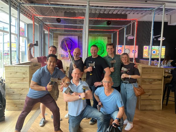 group of friends holding equipment for the games at No Name Bar and Games