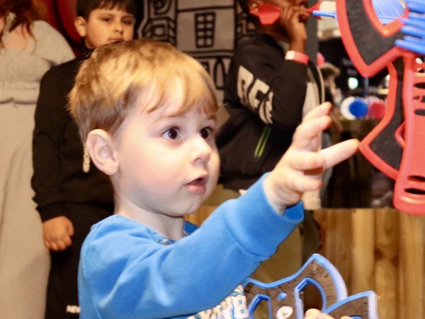child throwing axes during half term no name bar and games