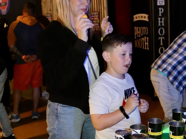 Mother and son playing beer pong at no name bar and games